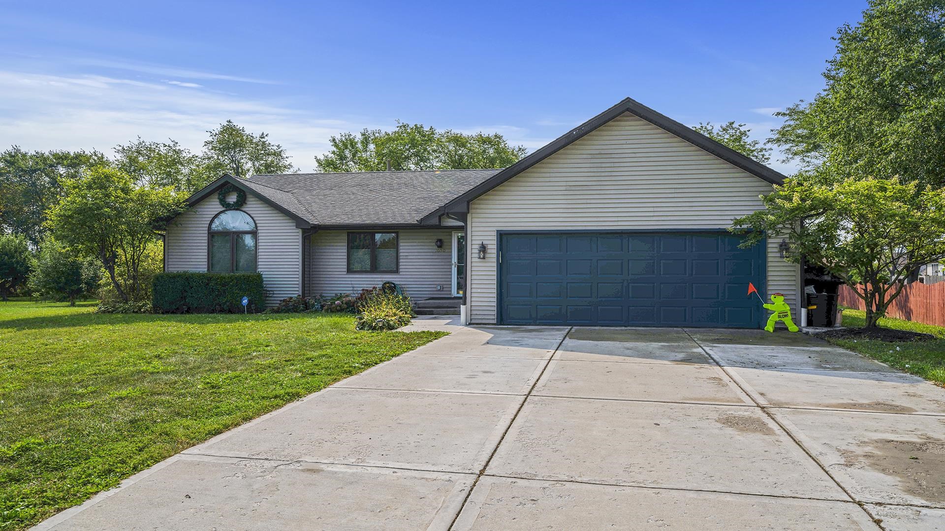 1050 South Trainer Road Rockford, IL 61108 - Photo 3 of 33 a front view of a house with a yard and garage