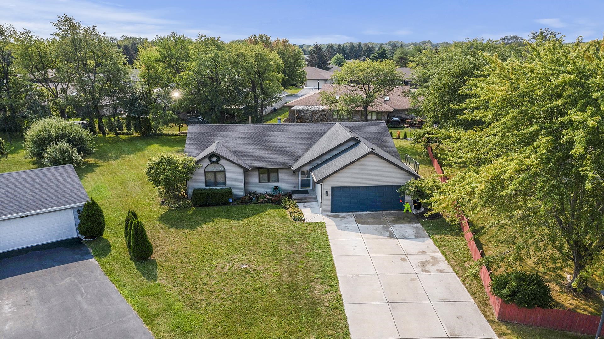 1050 South Trainer Road Rockford, IL 61108 - Photo 4 of 33 a view of a house with a big yard plants and large trees