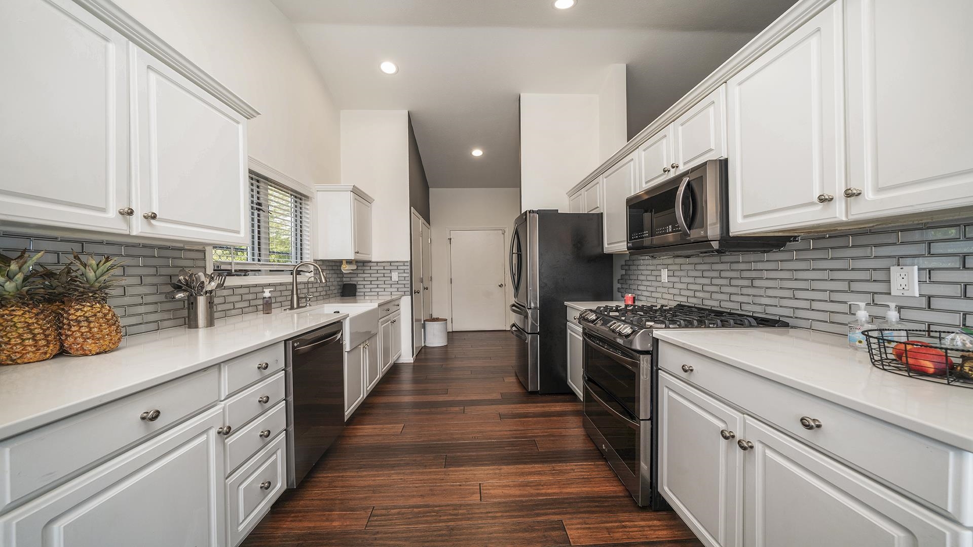 1050 South Trainer Road Rockford, IL 61108 - Photo 5 of 33 a kitchen with stainless steel appliances granite countertop lots of white cabinets a stove top oven a sink and dishwasher