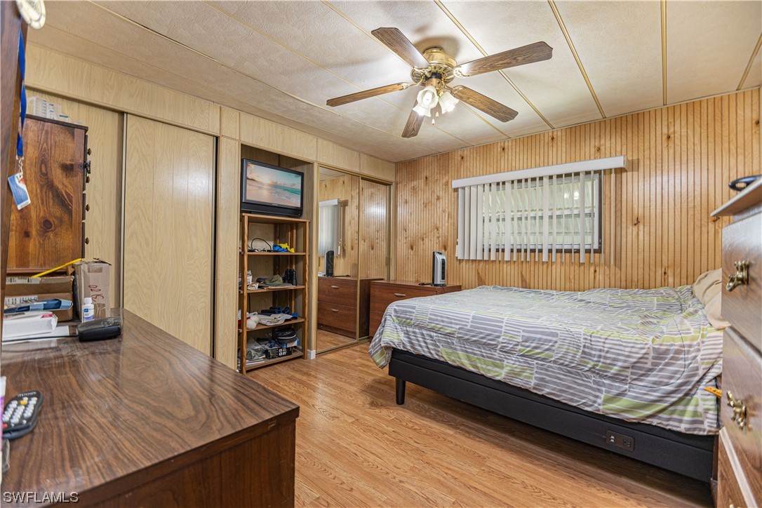 8 Henderson Drive Naples, FL 34114 - Photo 11 of 16 a bedroom with a large bed and a flat tv screen