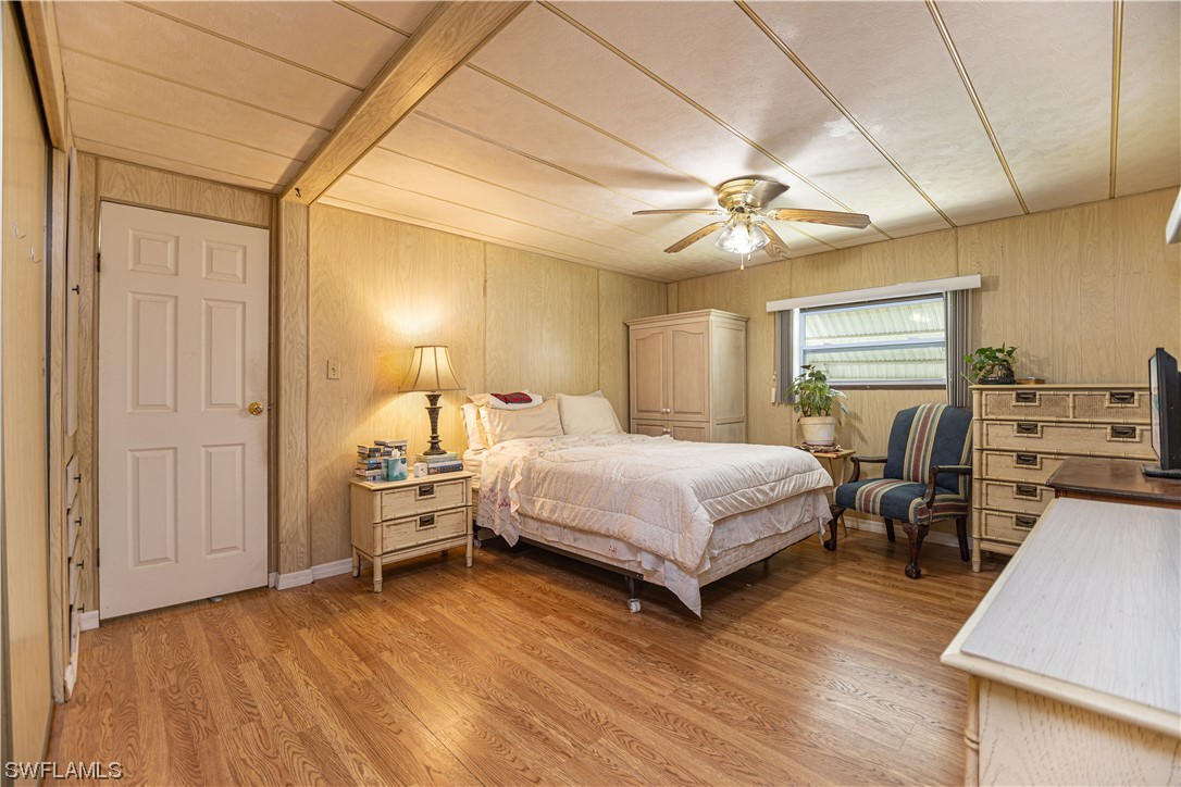 8 Henderson Drive Naples, FL 34114 - Photo 9 of 16 a bedroom with a bed and a chandelier