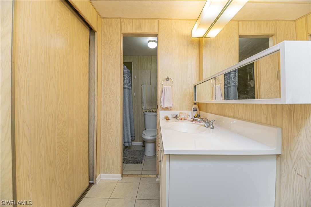 8 Henderson Drive Naples, FL 34114 - Photo 10 of 16 a bathroom with a sink and a mirror