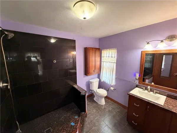 a bathroom with a sink vanity and a mirror