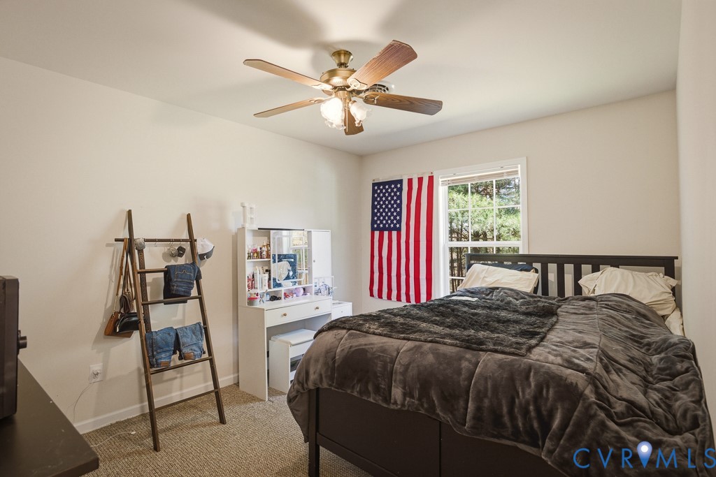 18262 Seals Road Bowling Green, VA 22427 - Photo 28 of 50 a bedroom with a bed and a chandelier