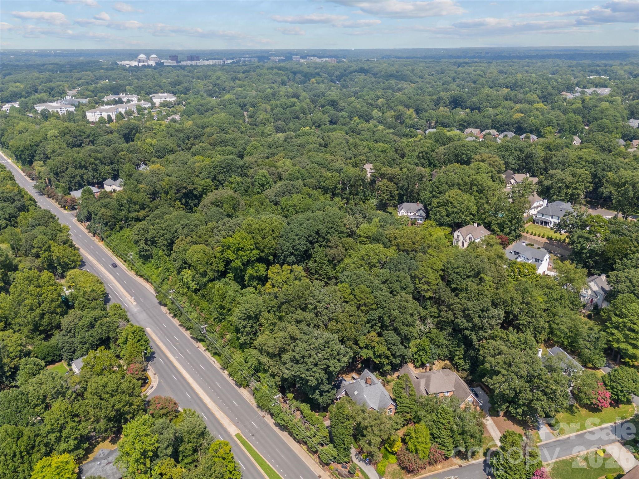 7707 Park Road Charlotte, NC 28210 - Photo 21 of 23 an aerial view of a house with a yard and mountain view in back