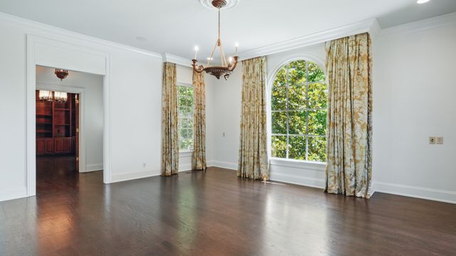 a view of a room with wooden floor and windows