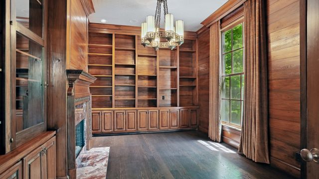 a bedroom with a bed and painting on the wall
