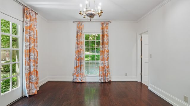 a front view of a house with a tree