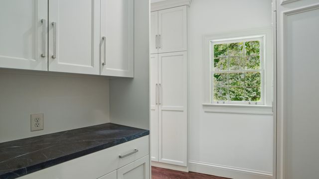 an aerial view of a houses with a lush green forest