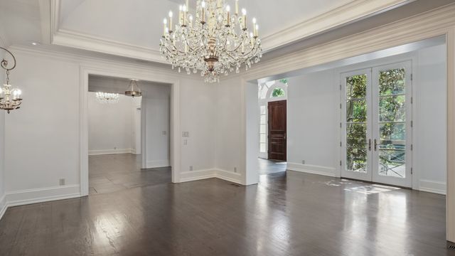 a view of a livingroom with wooden floor a fireplace and a window