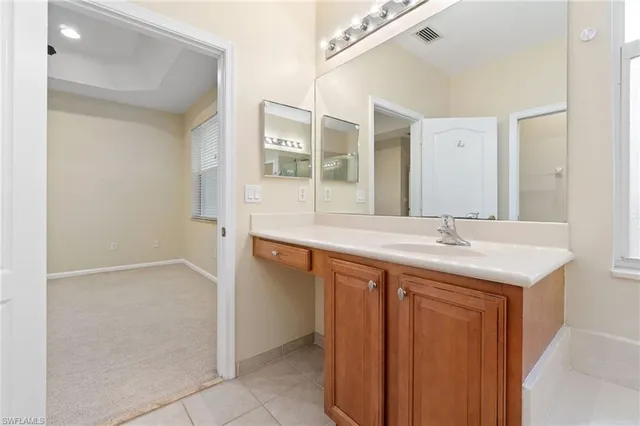 a spacious bathroom with a granite countertop sink mirror and a