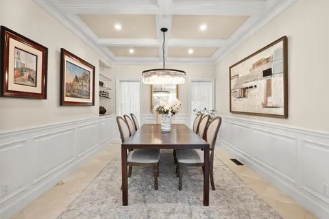 a view of a a dining room with furniture window and wooden floor