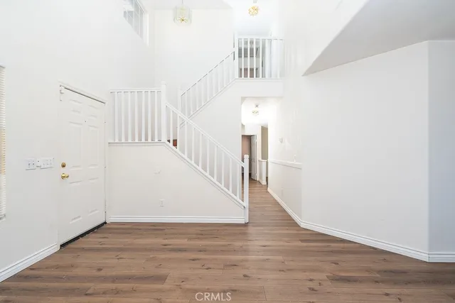 a view of entryway and hall with wooden floor