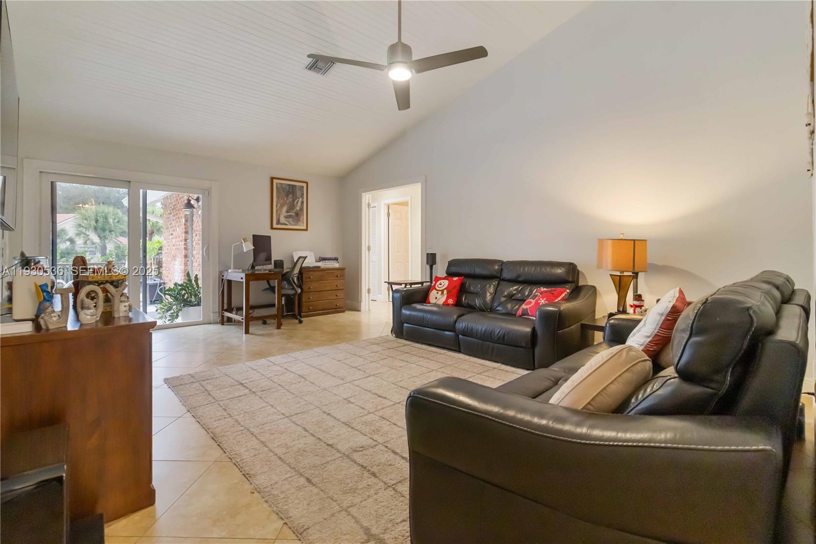 2047 Southwest 36th Avenue Delray Beach, FL 33445 - Photo 15 of 45 a living room with furniture and a chandelier