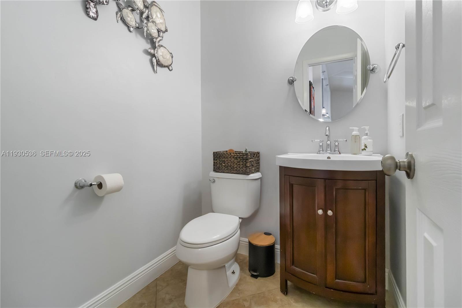 2047 Southwest 36th Avenue Delray Beach, FL 33445 - Photo 16 of 45 a bathroom with a toilet a sink and mirror
