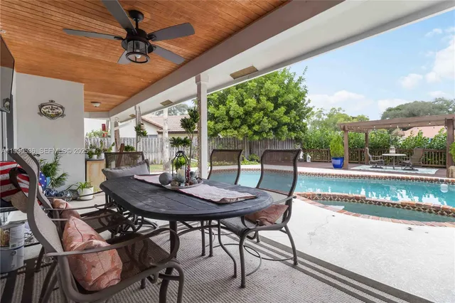 a view of a patio with table and chairs and potted plants