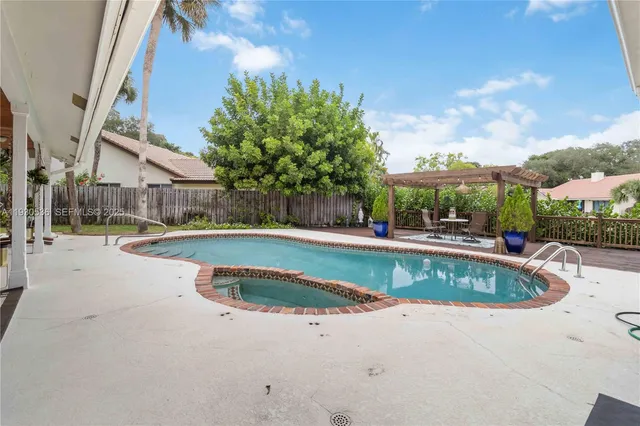 a view of a swimming pool with a patio