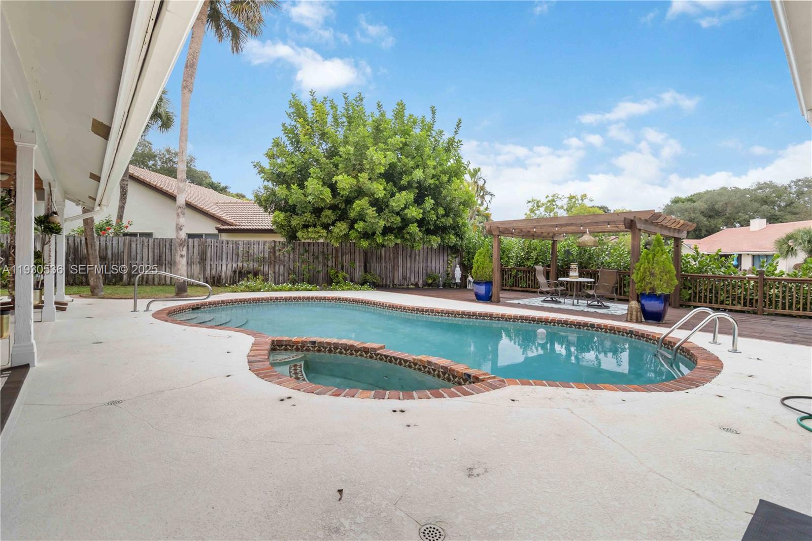 2047 Southwest 36th Avenue Delray Beach, FL 33445 - Photo 18 of 45 a view of a swimming pool with a patio