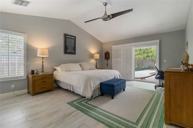 a spacious bedroom with a bed a couch and dresser