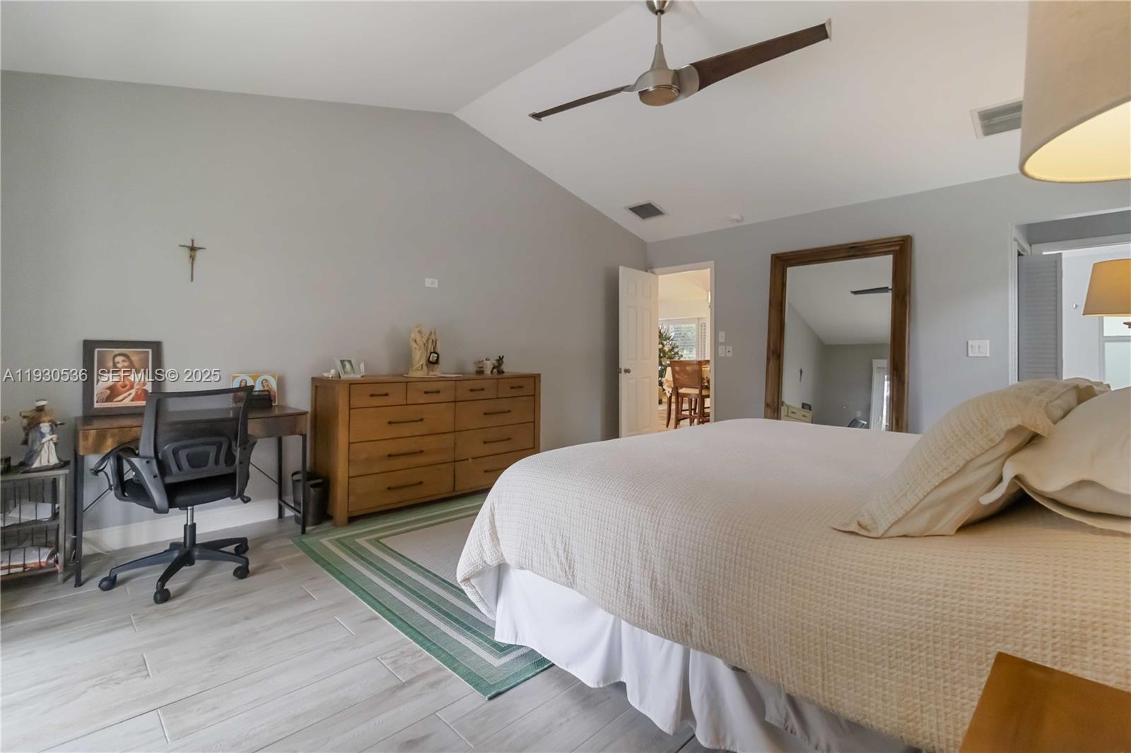 2047 Southwest 36th Avenue Delray Beach, FL 33445 - Photo 21 of 45 a bedroom with a bed a desk and chair