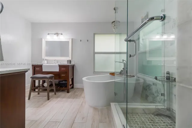 a bathroom with a sink a toilet a glass door shower and mirror