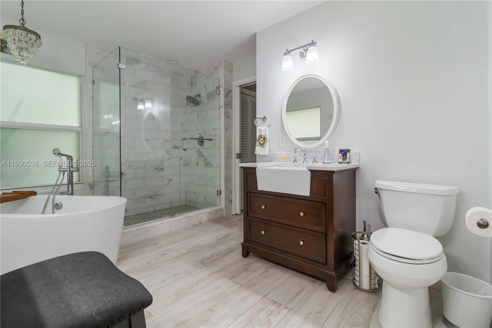 2047 Southwest 36th Avenue Delray Beach, FL 33445 - Photo 23 of 45 a bathroom with a toilet a sink and mirror