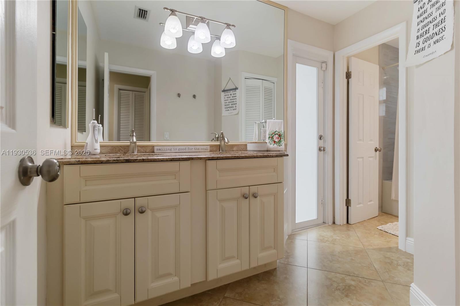 2047 Southwest 36th Avenue Delray Beach, FL 33445 - Photo 25 of 45 a bathroom with a sink and a mirror