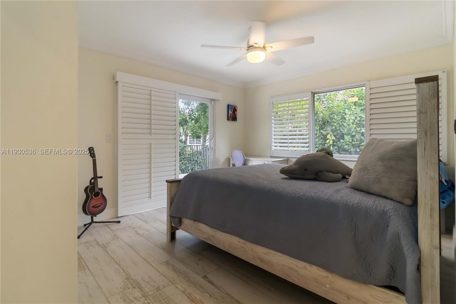 2047 Southwest 36th Avenue Delray Beach, FL 33445 - Photo 27 of 45 a bedroom with a bed and a chandelier