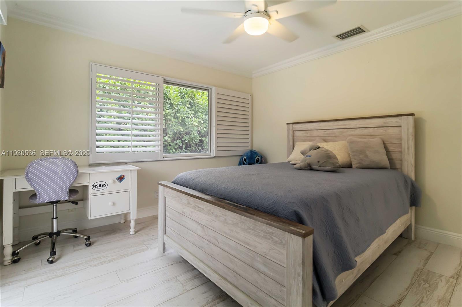 2047 Southwest 36th Avenue Delray Beach, FL 33445 - Photo 28 of 45 a bedroom with a bed and a chair