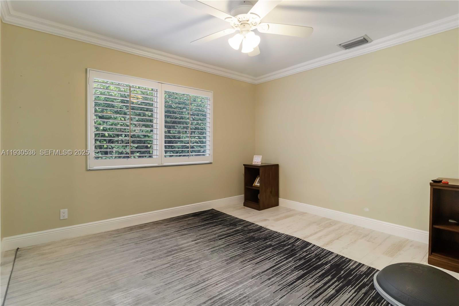 2047 Southwest 36th Avenue Delray Beach, FL 33445 - Photo 29 of 45 a view of an empty room with wooden floor and a window
