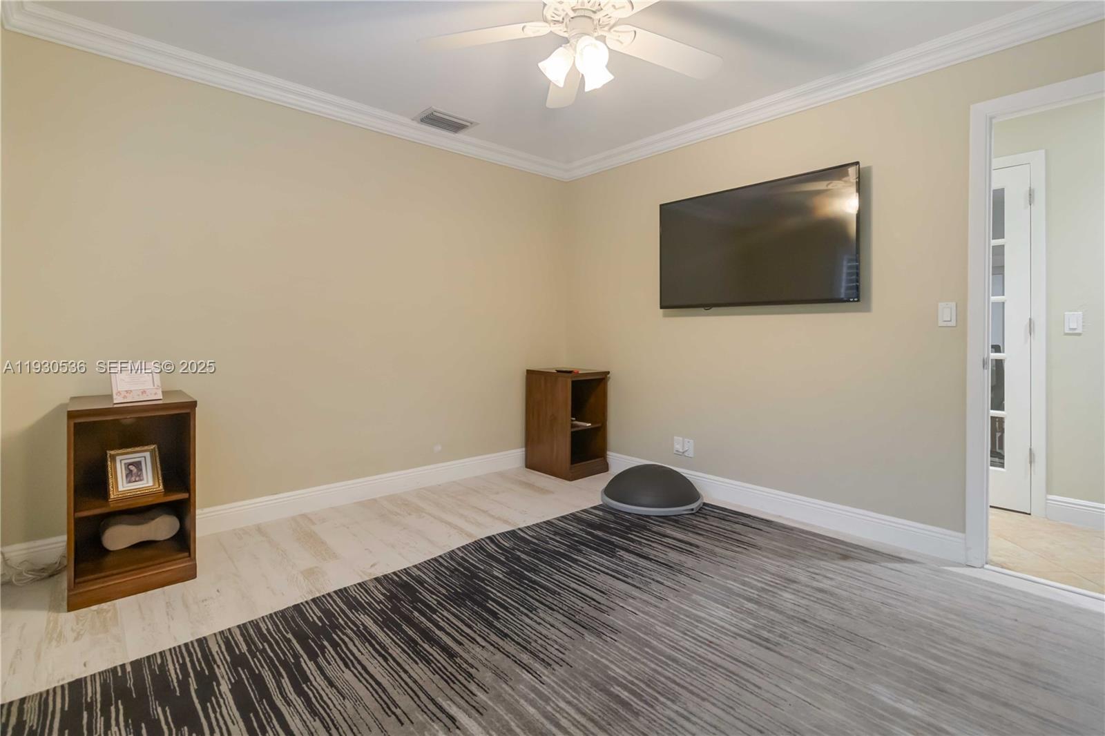 2047 Southwest 36th Avenue Delray Beach, FL 33445 - Photo 30 of 45 a view of an empty room with wooden floor and a window