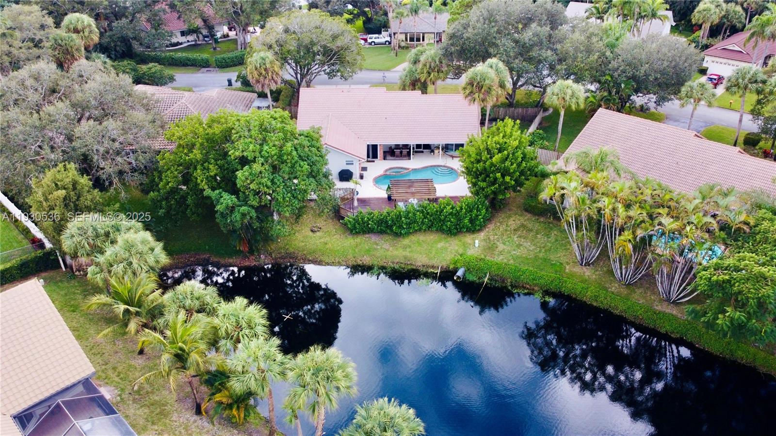 2047 Southwest 36th Avenue Delray Beach, FL 33445 - Photo 3 of 45 an aerial view of a house with a yard and garden