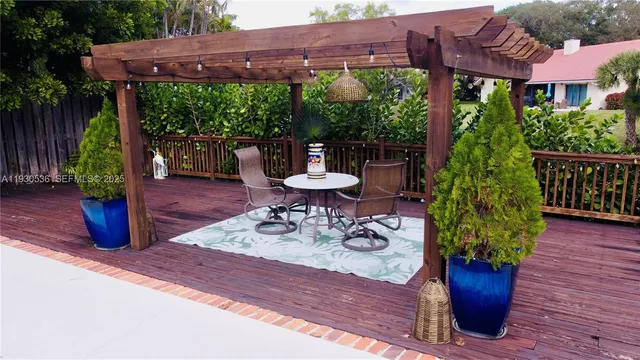a view of a table and chairs in patio with wooden fence