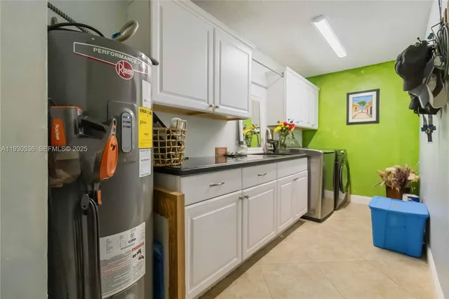 a kitchen with a sink appliances and cabinets