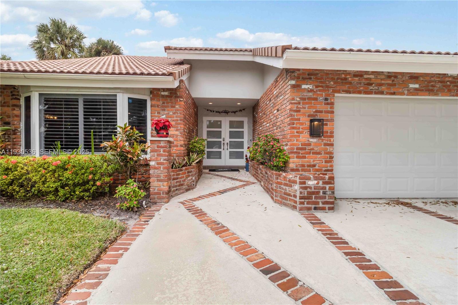 2047 Southwest 36th Avenue Delray Beach, FL 33445 - Photo 5 of 45 a front view of a house with garden