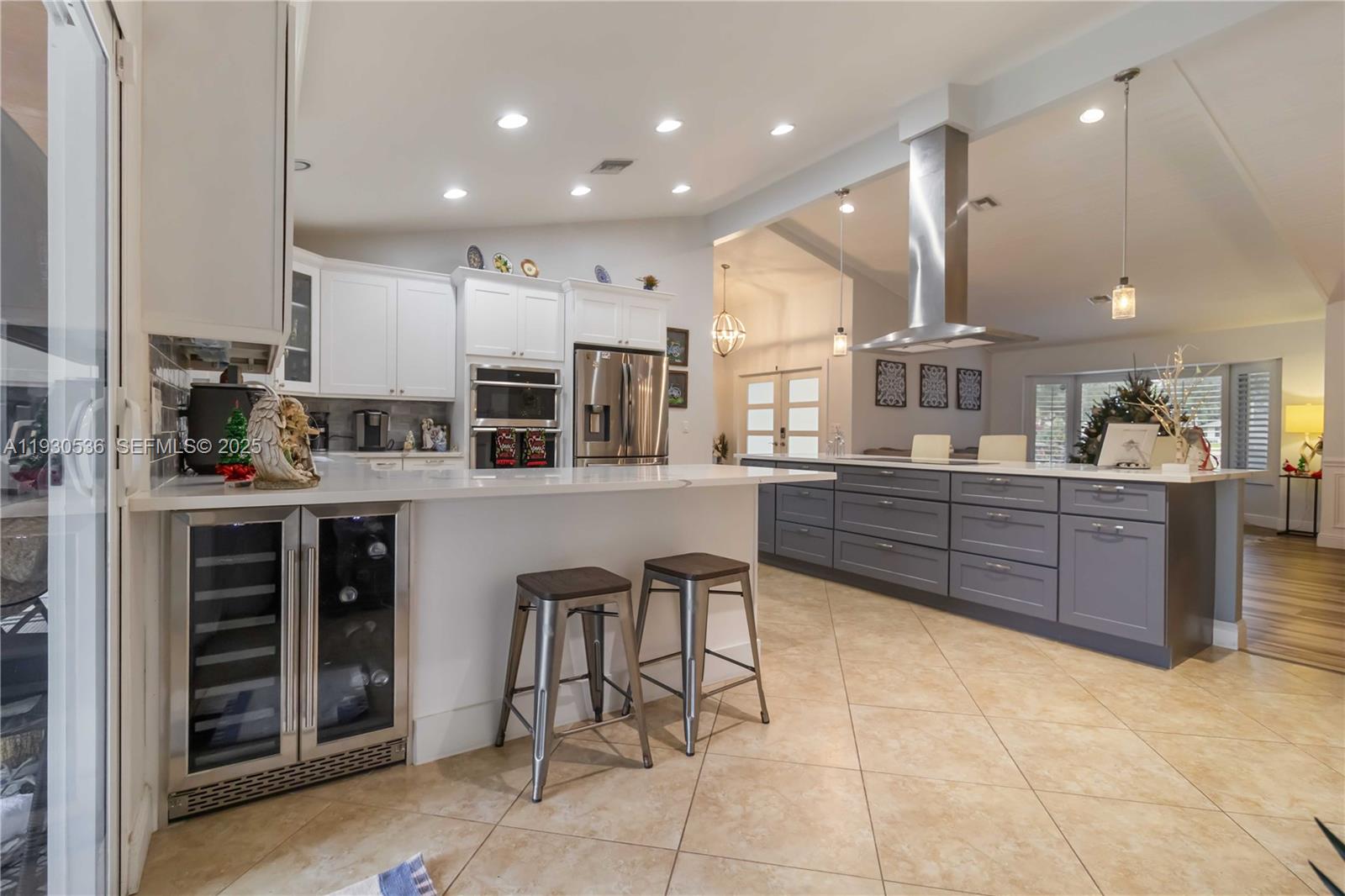 2047 Southwest 36th Avenue Delray Beach, FL 33445 - Photo 6 of 45 a kitchen with stainless steel appliances kitchen island granite countertop a stove a sink a refrigerator and a cabinets