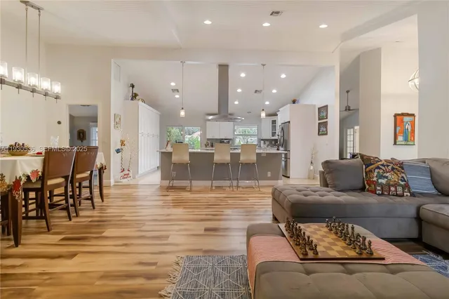 a living room with furniture and kitchen view
