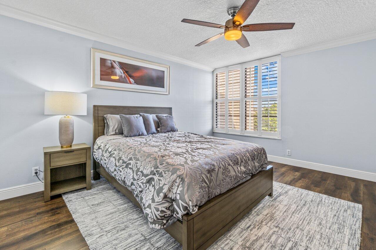 14 Royal Palm Way, Unit 504 Boca Raton, FL 33432 - Photo 15 of 22 a bedroom with bed and wooden floor