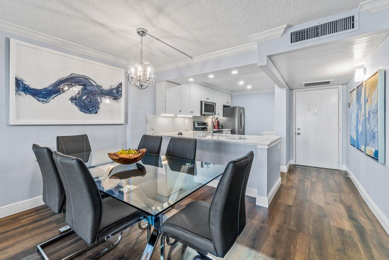 14 Royal Palm Way, Unit 504 Boca Raton, FL 33432 - Photo 5 of 22 a view of a dining room with furniture window and wooden floor