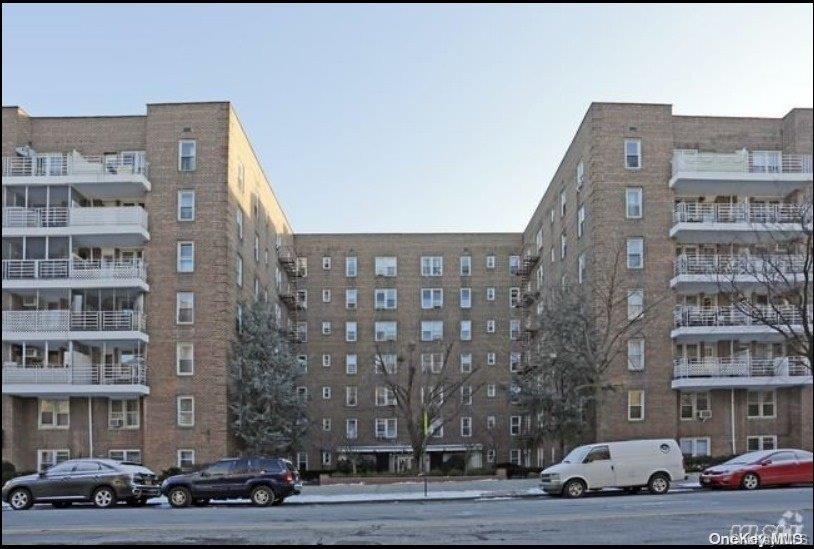 62-59 108th Street, Unit 3A Queens, NY 11375 - Photo 1 of 1 a front view of a building with lot of cars parked