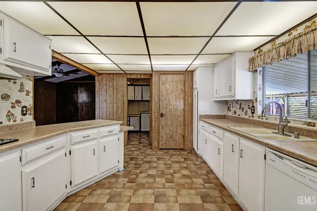 a kitchen with stainless steel appliances granite countertop a sink and cabinets