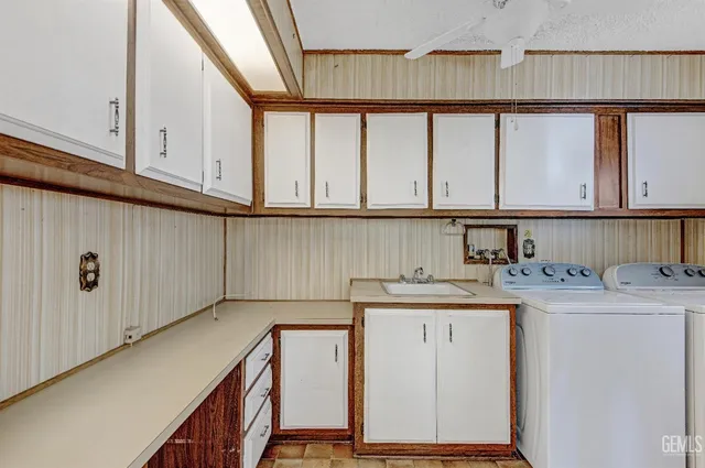 a kitchen with a sink a cabinets and window