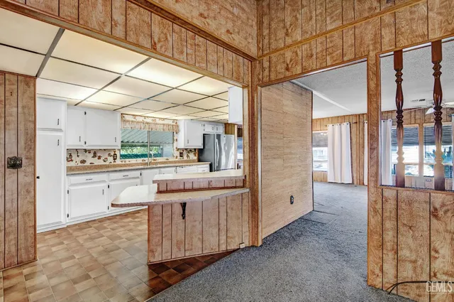 a kitchen with white cabinets and white appliances