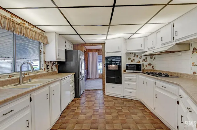 a kitchen with stainless steel appliances granite countertop a sink and cabinets