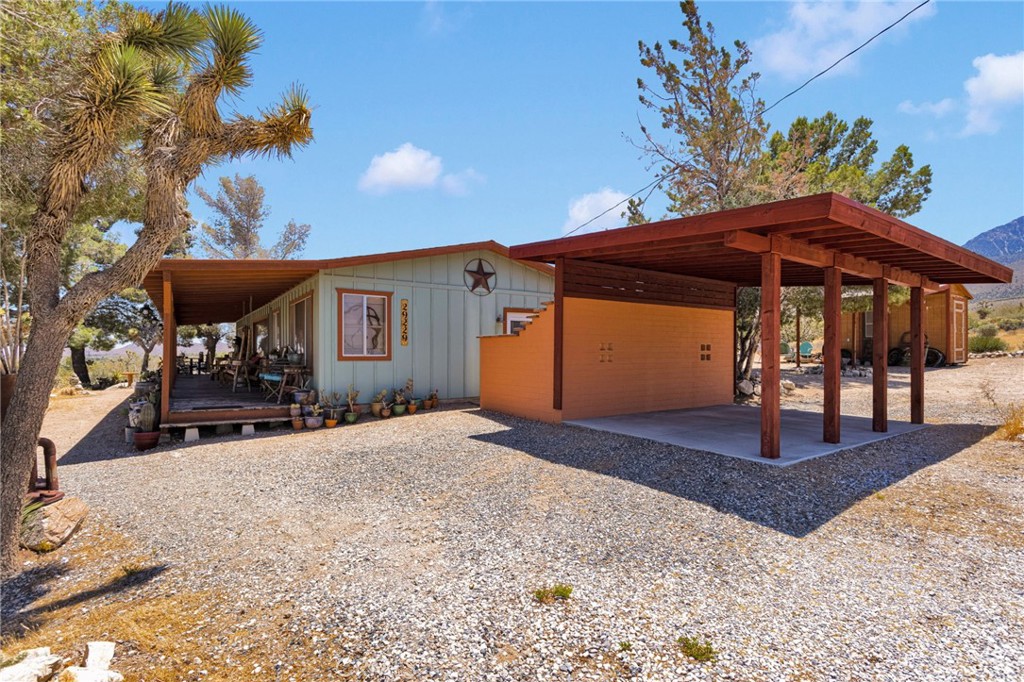 29229 Santa Rosa Road Lucerne Valley, CA 92356 - Photo 11 of 74 a front view of a house with a yard and garage