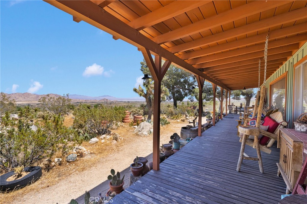 29229 Santa Rosa Road Lucerne Valley, CA 92356 - Photo 13 of 74 a view of a balcony with chairs and wooden floor