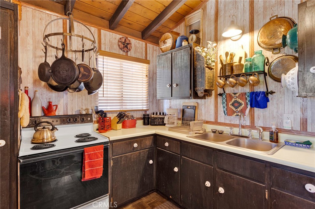 29229 Santa Rosa Road Lucerne Valley, CA 92356 - Photo 30 of 74 a kitchen with stainless steel appliances granite countertop a sink a stove and a wooden floors