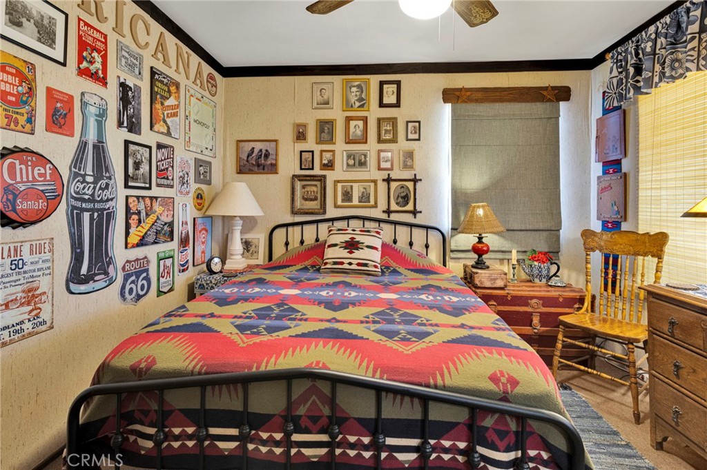 29229 Santa Rosa Road Lucerne Valley, CA 92356 - Photo 39 of 74 a bedroom with a bed a table and a large mirror