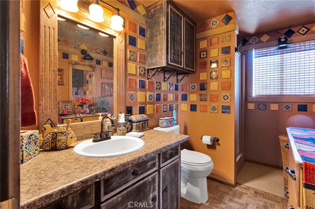 29229 Santa Rosa Road Lucerne Valley, CA 92356 - Photo 42 of 74 a bathroom with a granite countertop sink toilet and shower