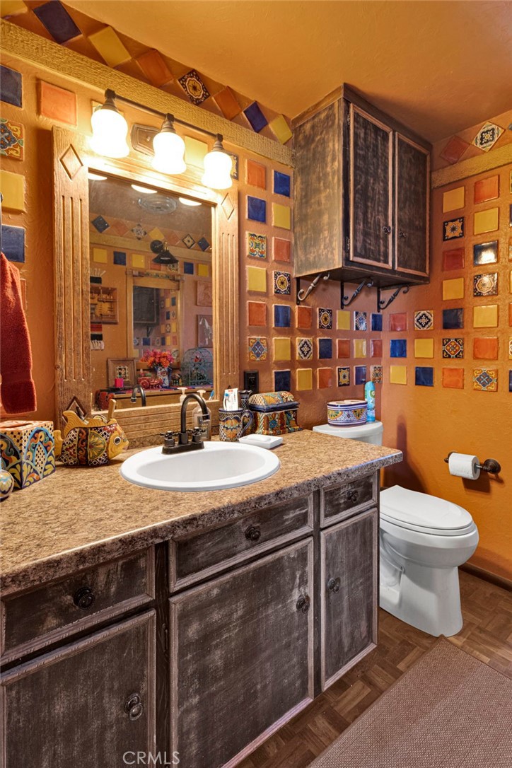 29229 Santa Rosa Road Lucerne Valley, CA 92356 - Photo 43 of 74 a bathroom with a sink a toilet and mirror